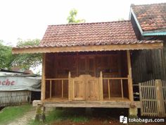 a small wooden house sitting in the grass