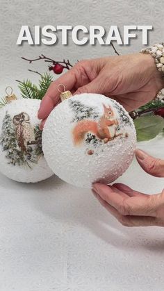 two handmade christmas ornaments are being held by someone