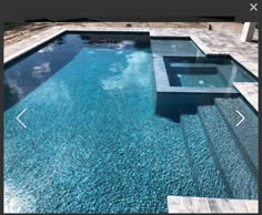 an empty swimming pool surrounded by stone steps