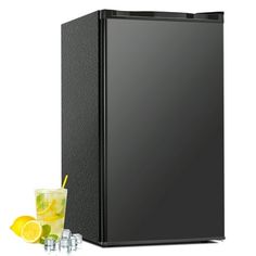 a small black refrigerator next to two glasses with lemons and ice cubes on the side