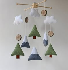 a mobile with trees and clouds hanging from it