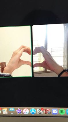 two hands making a heart with their fingers on a computer screen showing the same time