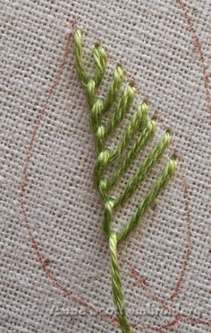 a close up of a piece of cloth with green thread