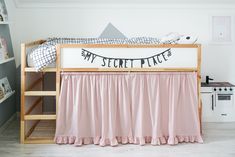 there is a bed with pink ruffled bedspread on it and a sign that says, my secret place