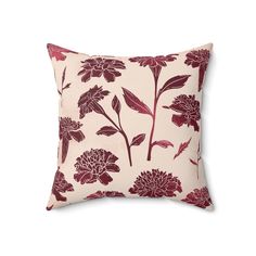 a red and white floral pillow on a white background with dark pink flowers in the middle