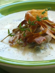 a green and white bowl filled with soup