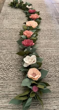 a long row of paper flowers sitting on top of a rug