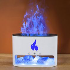 a white and blue flame is on top of a table