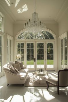 a living room with two couches and a chandelier