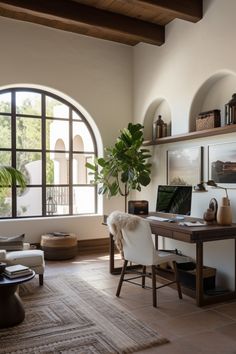 a living room filled with furniture and a large window covered in lots of natural light