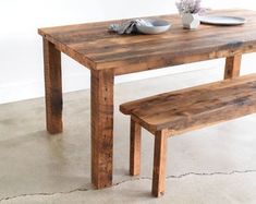 a wooden table with two benches next to it and a plate on the table top