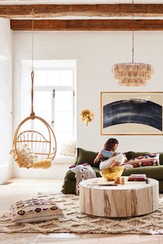 a woman sitting on top of a couch in a living room