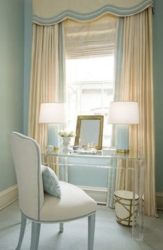 a bedroom with blue walls and white furniture