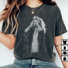 a woman with long hair wearing a t - shirt that has an image of dolly monroe on it