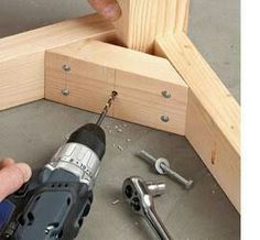 a man is using a drill to attach the frame with screwdrivers and hammers