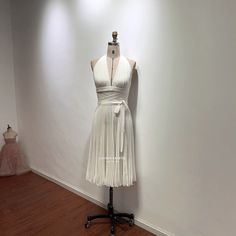 This midi-length white halter v-neck dress with pleated skirt is an iconic dress from 1950s movies. I recreate the subway white dress with crepe fabric, the fabric was pleated by machine, which is thick, isn't see through.  This dress can be made to order in custom size. For custom size, please message me your bust/waist/hips measurements and your height. Below are the measurements of standard size 2 to size 12 in inches: Size 2(inches): Bust=32 Waist=25 Hips=35 Height=65 Size 4(inches): Bust=33 Mariyln Monroe Dresses, White Velour Dresses, Luxury Fitted White Vintage Dress, Fenity Monica Dress, Marilyn Monroe Subway Dress, West Side Story White Dress, Main Character White Dress, 70s Party Dress White, Luxury White Retro Dress