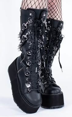 Dayum! These flatform boots are perfect for those who want some height with their stompy af boots without having to totter around on a heel. Black vegan leather. 3 1/2 inch (90mm) platform. Lace-up knee-high boots. Alternating O-Ring and eyelet lacing. Removable spike studded hanging straps. Outer side zip closure. U.S. women sizing - refer to the size chart for more info. Frankie Cosplay, Pleaser High Heels, Mary Janes Flats, Alt Shoes, Punk Festival, Couture Heels, Platform Shoes Boots, Demonia Boots, Alternative Shoes