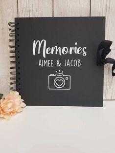 a black notebook with the words memories, aime and jacob written on it