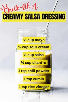 a jar filled with creamy salsa dressing on top of a table