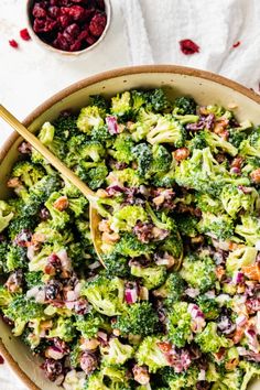 a bowl filled with broccoli and cranberries