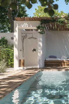 an outdoor shower in the middle of a pool