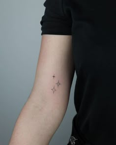 a woman with a small star tattoo on her arm