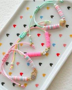 three bracelets on a tray with hearts