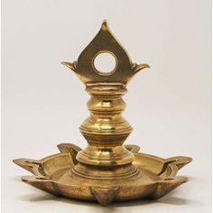 an ornate brass candle holder on a white background