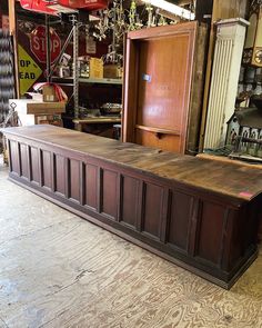 a large wooden bench sitting inside of a shop