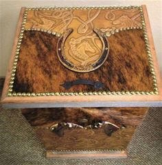 a wooden box with an ornate design on the top and bottom, sitting on carpeted floor