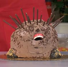 a cake with chocolate frosting and spiky spikes on it's head