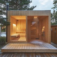 an outdoor sauna with wooden decking and hot tub