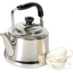 a tea kettle with two cups next to it