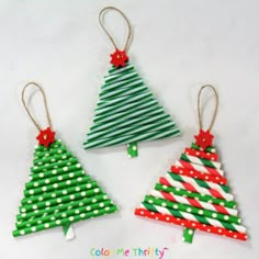 three small christmas trees made out of popsicle sticks and paper straws with bows on them