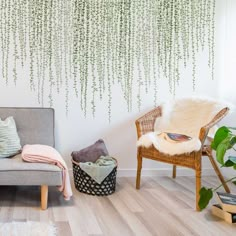 a living room with a couch, chair and potted plant on the wall in front of it