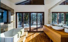 a large bathroom with two sinks and a bathtub in the middle of the room