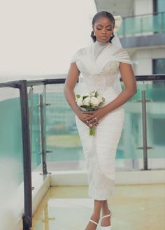 a woman in a white dress holding a bouquet