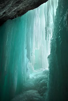 an ice cave with water flowing down the side