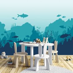 a table and chairs in front of an underwater scene