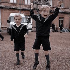 two young boys are jumping in the air