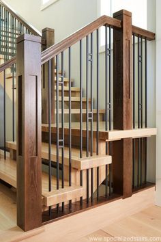 a wooden staircase with metal handrails in a home