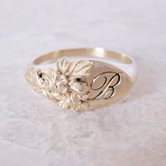 This vintage-inspired floral ring is a row of dainty flowers wrapped around your fingers. Handmade and polished, it is available in solid 8K and 14K gold. This item is engravable with text or monogram of your choice at no extra cost. The initals are engraved onto the ring and embedded in the 3D model for a flawless embossed finish. It is also possible to add a diamond or birthstone or diamond to this ring at an additional fee. Please inquire for details. A few notes about our gold: - Though we d Luxury Brilliant Cut Engraved Ring, Luxury Wedding Signet Ring With Single Diamond, Luxury Gold Signet Ring With Diamond Accents, Luxury Art Deco Signet Ring As A Gift, Luxury Gold Signet Ring With Halo Setting, Luxury Vintage Signet Ring With Diamond Accents, Luxury Art Deco Signet Ring For Gift, Luxury Antique Engraved Ring For Commemoration, Luxury Ceremonial Hallmarked Signet Ring