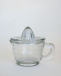 a glass measuring cup with a lid