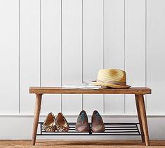 a wooden bench with shoes on it and a hat sitting on top of the shelf