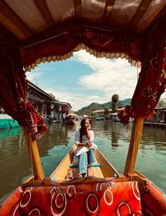 a woman sitting in the bow of a boat