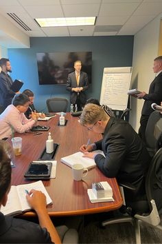 a group of people sitting around a conference table