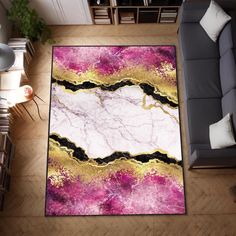 a living room area rug with pink, gold and black marble design on the floor