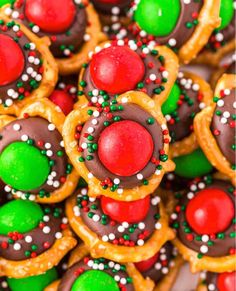 many decorated cookies and pretzels are arranged together