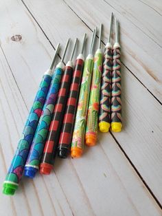 five pens lined up on top of each other with different designs and colors in them