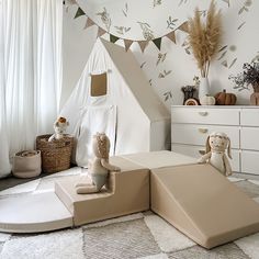 a child's bedroom with a teepee tent and stuffed animals